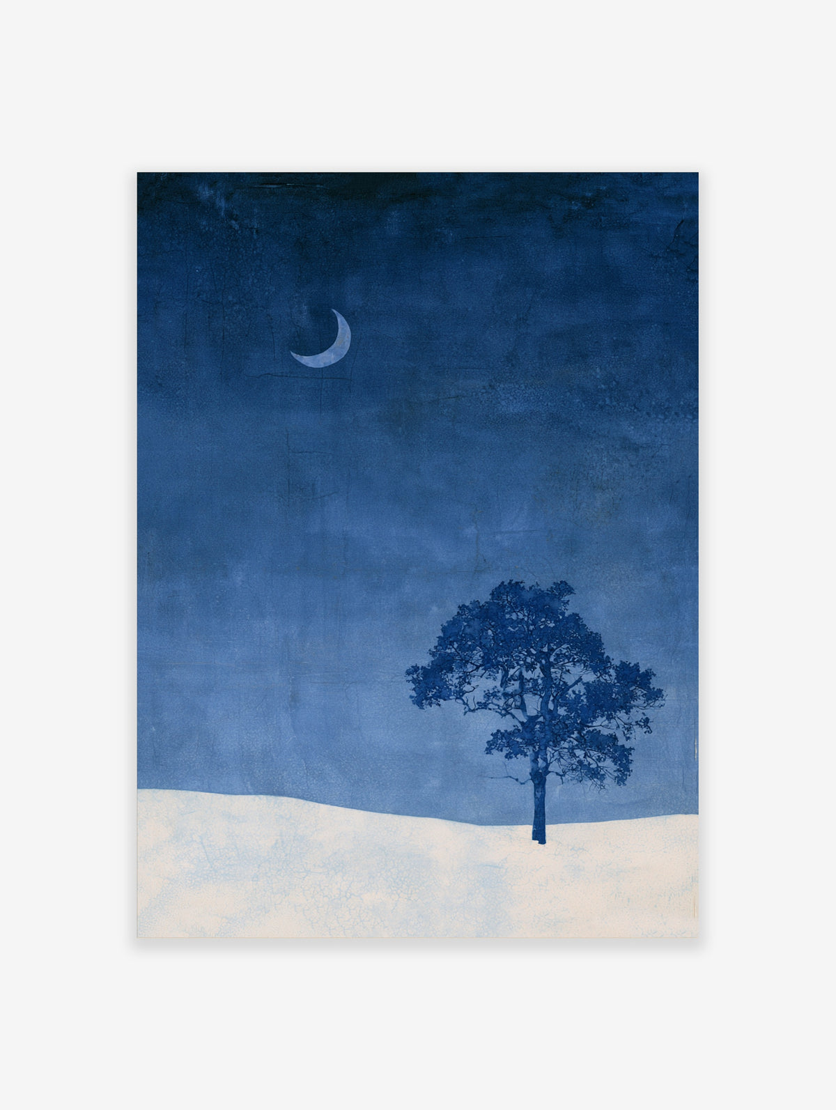 Minimalist wall art print of a single tree and crescent moon over a snowy landscape in deep blue and white