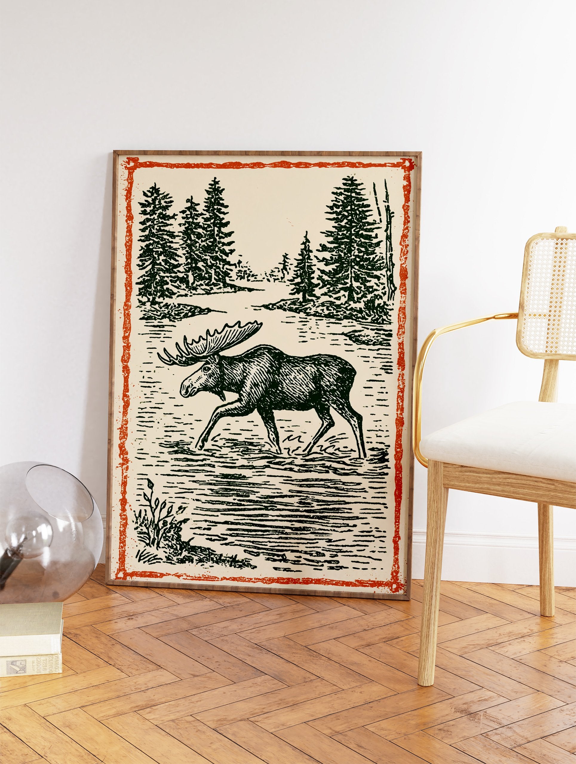 Vintage moose wall art illustration print showing a moose wading in a forest lake with pine trees and an orange border. - Image 2