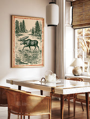 Vintage moose wall art illustration print showing a moose wading in a forest lake with pine trees and an orange border. - Image 3
