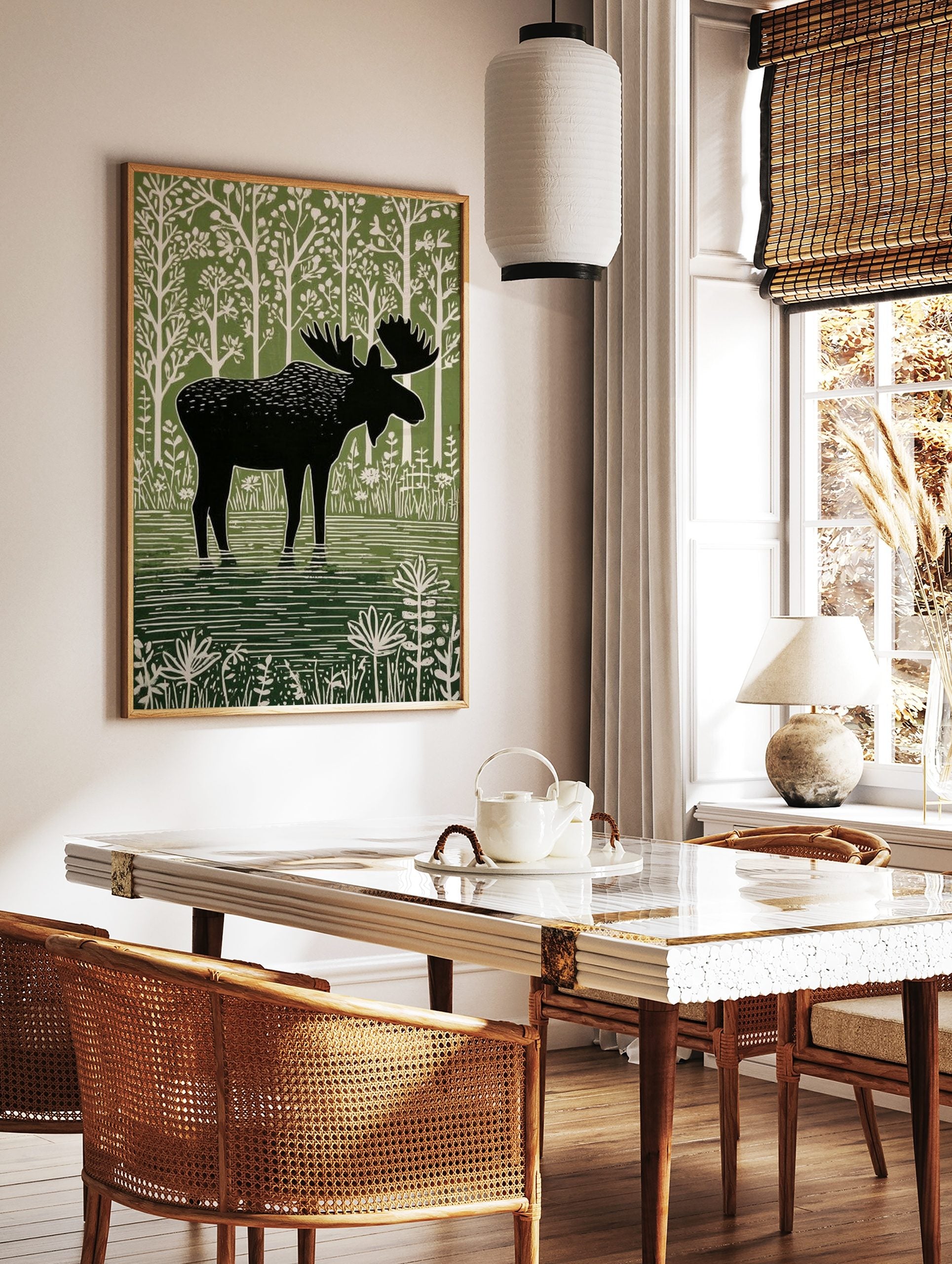 Moose illustration print, black silhouette moose in green water, white stylised trees and plants, in a styled room mockup