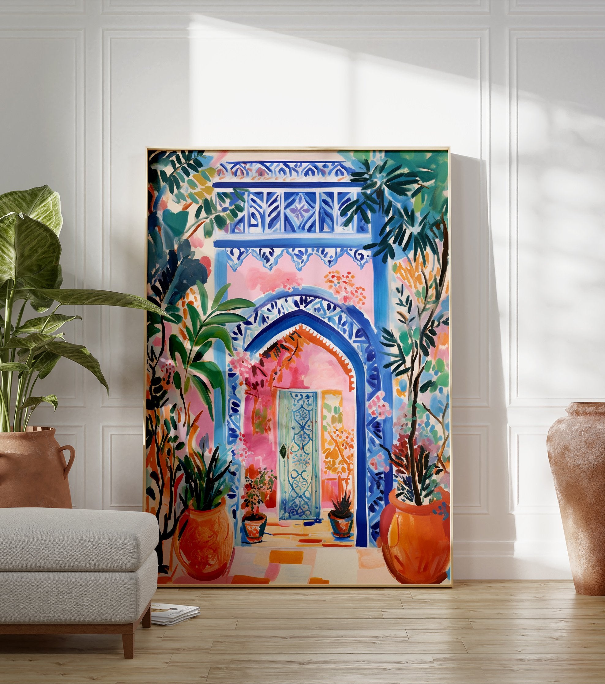 Vibrant Moroccan Archway Poster with blue intricate patterns, a pink wall, and lush green and orange potted plants. - Image 3
