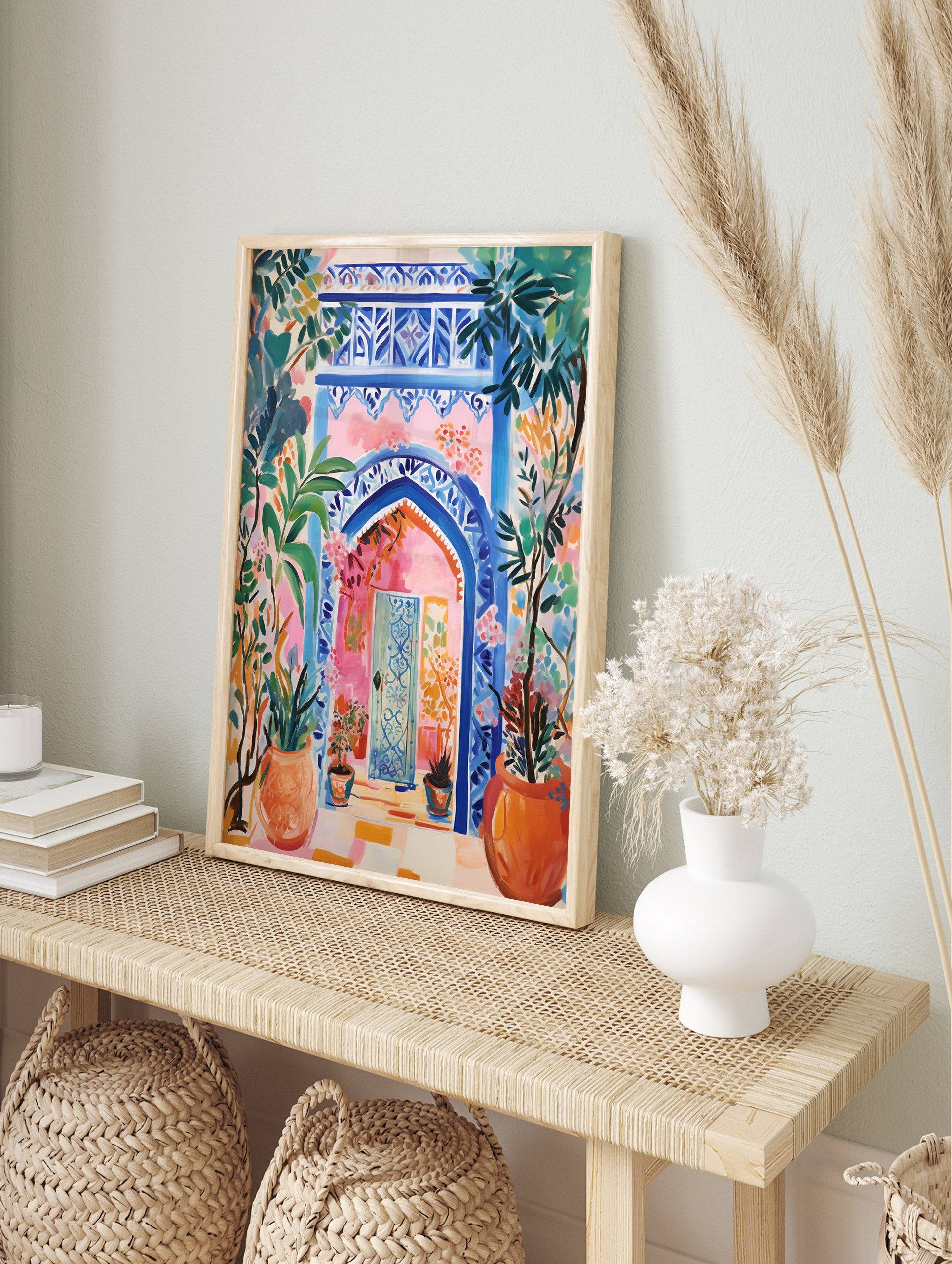 Vibrant Moroccan Archway Poster with blue intricate patterns, a pink wall, and lush green and orange potted plants. - Image 4