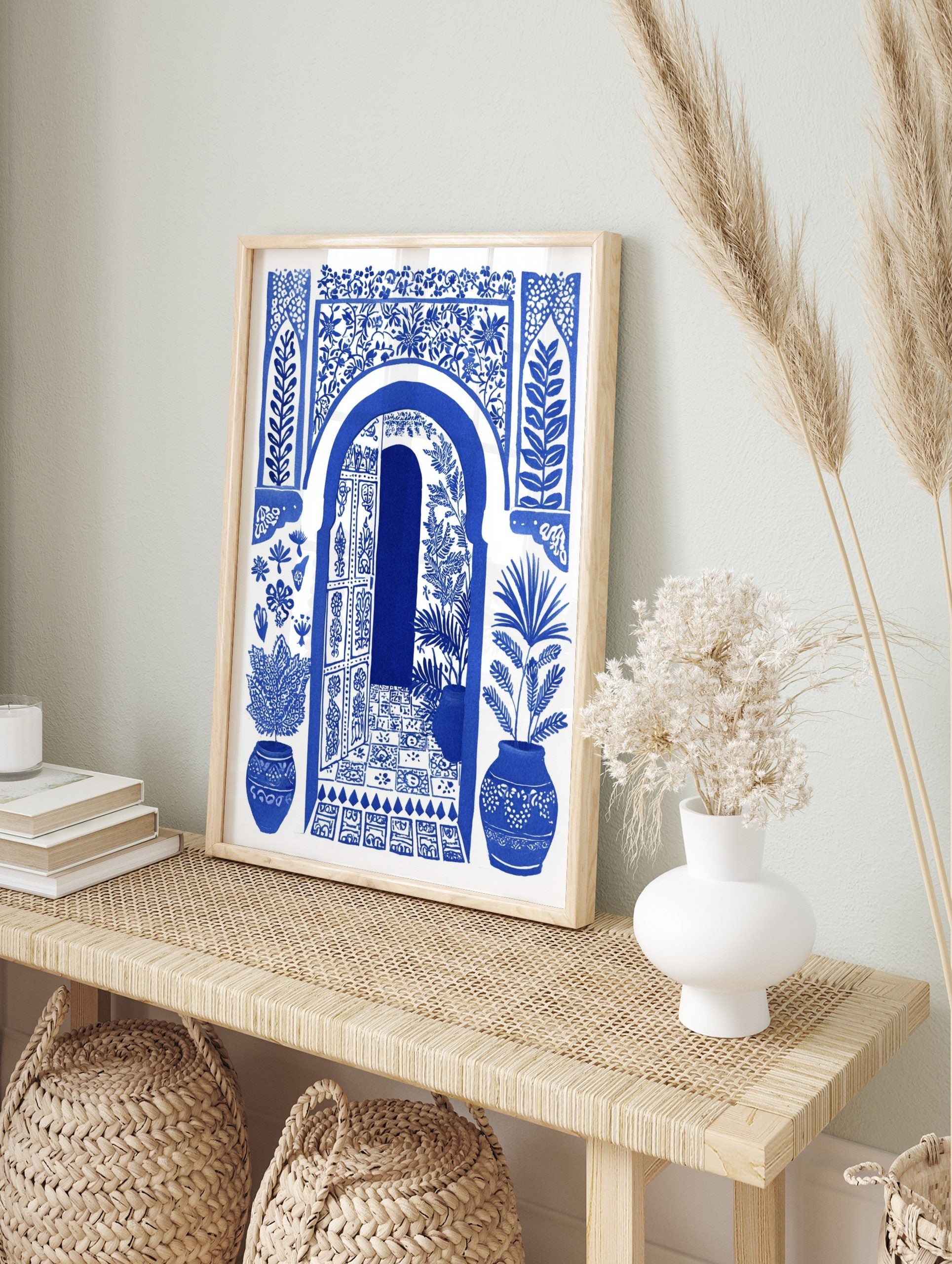 Blue and white illustrative art print of a Moroccan arched doorway with open door, botanical, in an alternate framed mockup