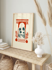 Red Moroccan archway framing teal palm trees and water, with red potted plants, illustrative, in an alternate framed mockup