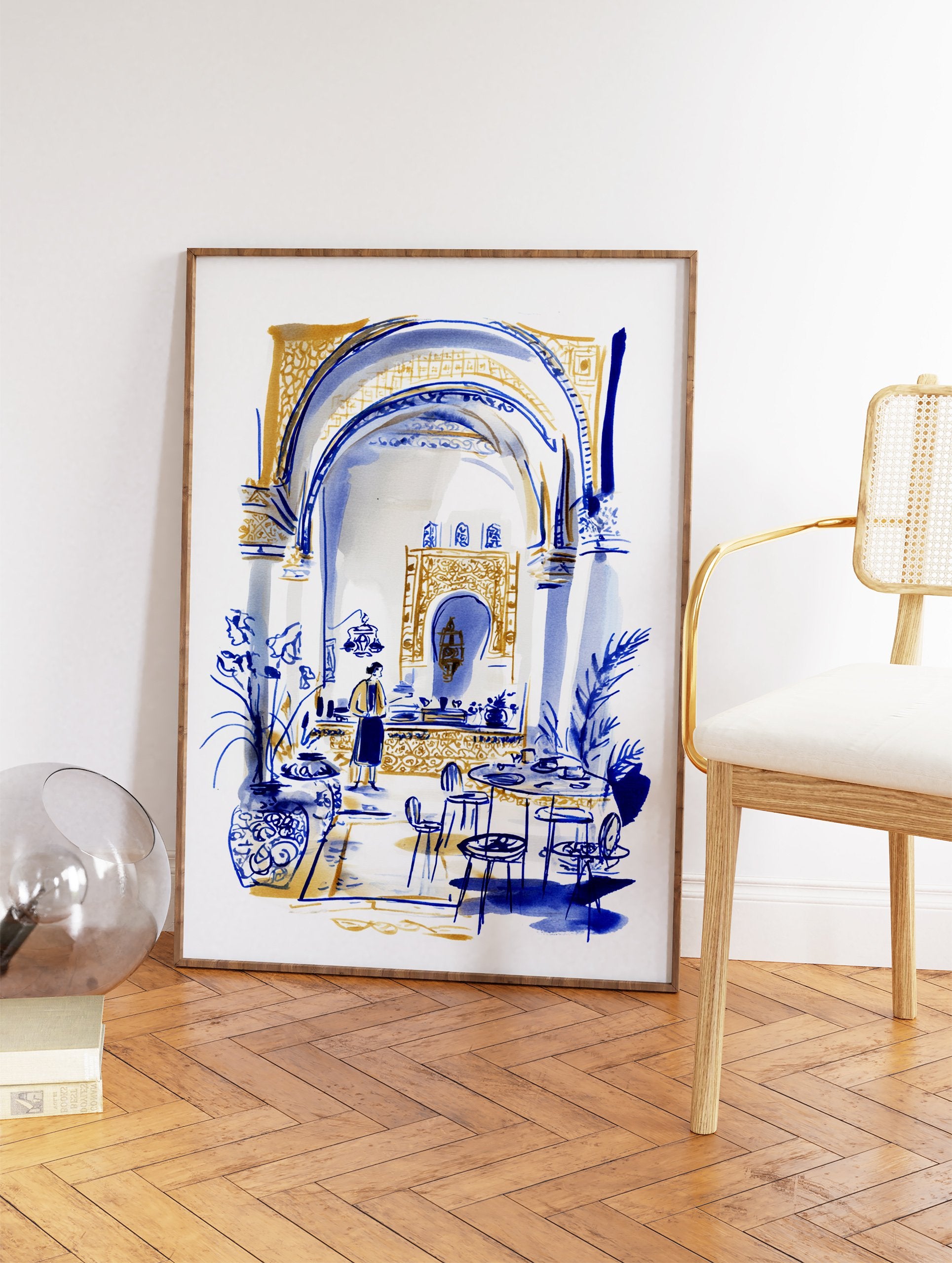 Moroccan interior wall art illustration in blue and gold, depicting a cafe scene with arches, tables, and a person. - Image 2
