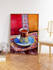 Watercolor painting of a Moroccan tea cup on a patterned rug with red and orange cushions in the background. - Image 2