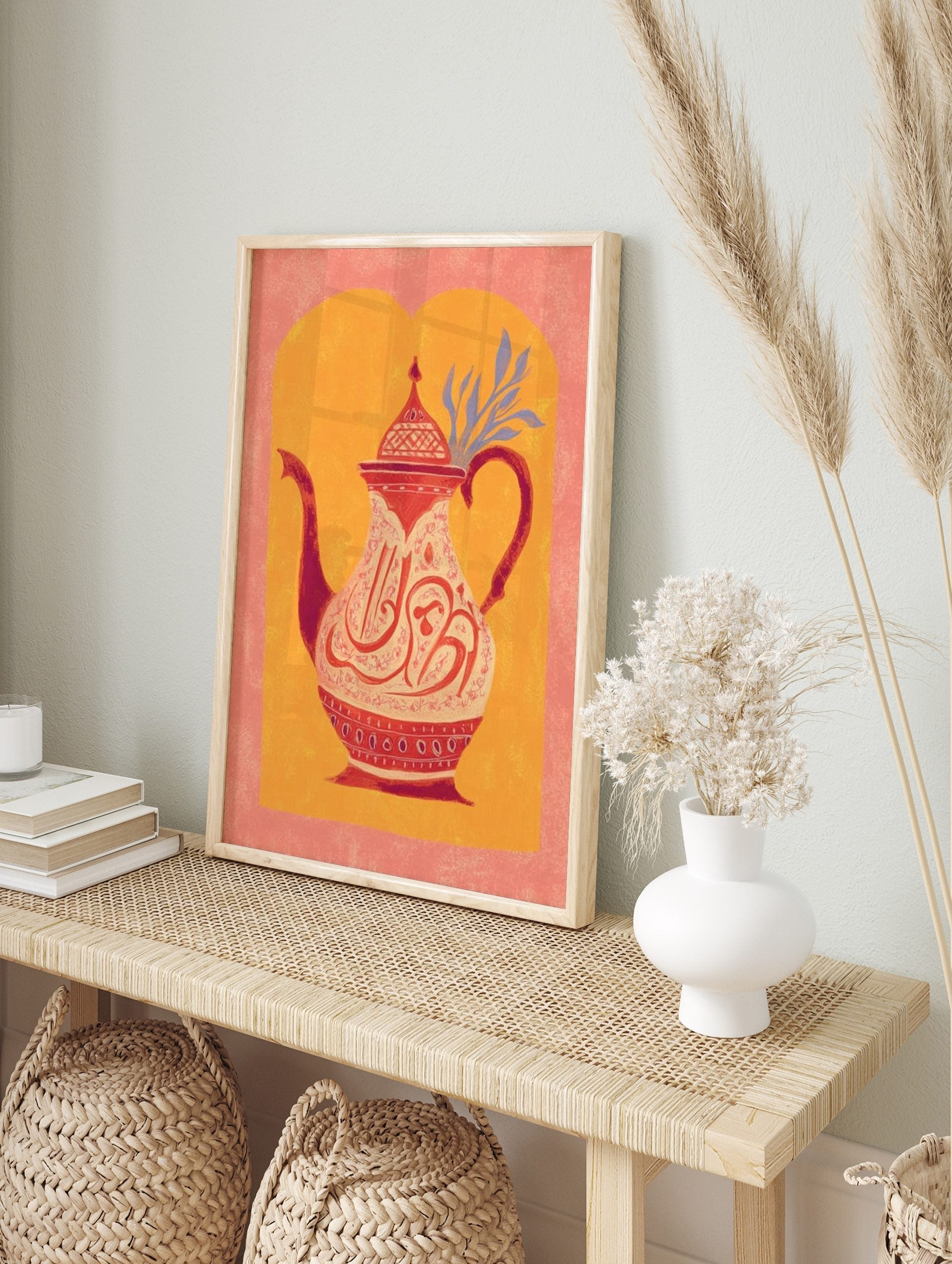 Illustrative Moroccan teapot with ornate red and white Arabic calligraphy and patterns on an, in an alternate framed mockup