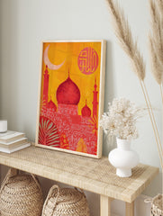 Red mosque with domes and minarets against an orange sky, with a crescent moon and Arabic, in an alternate framed mockup