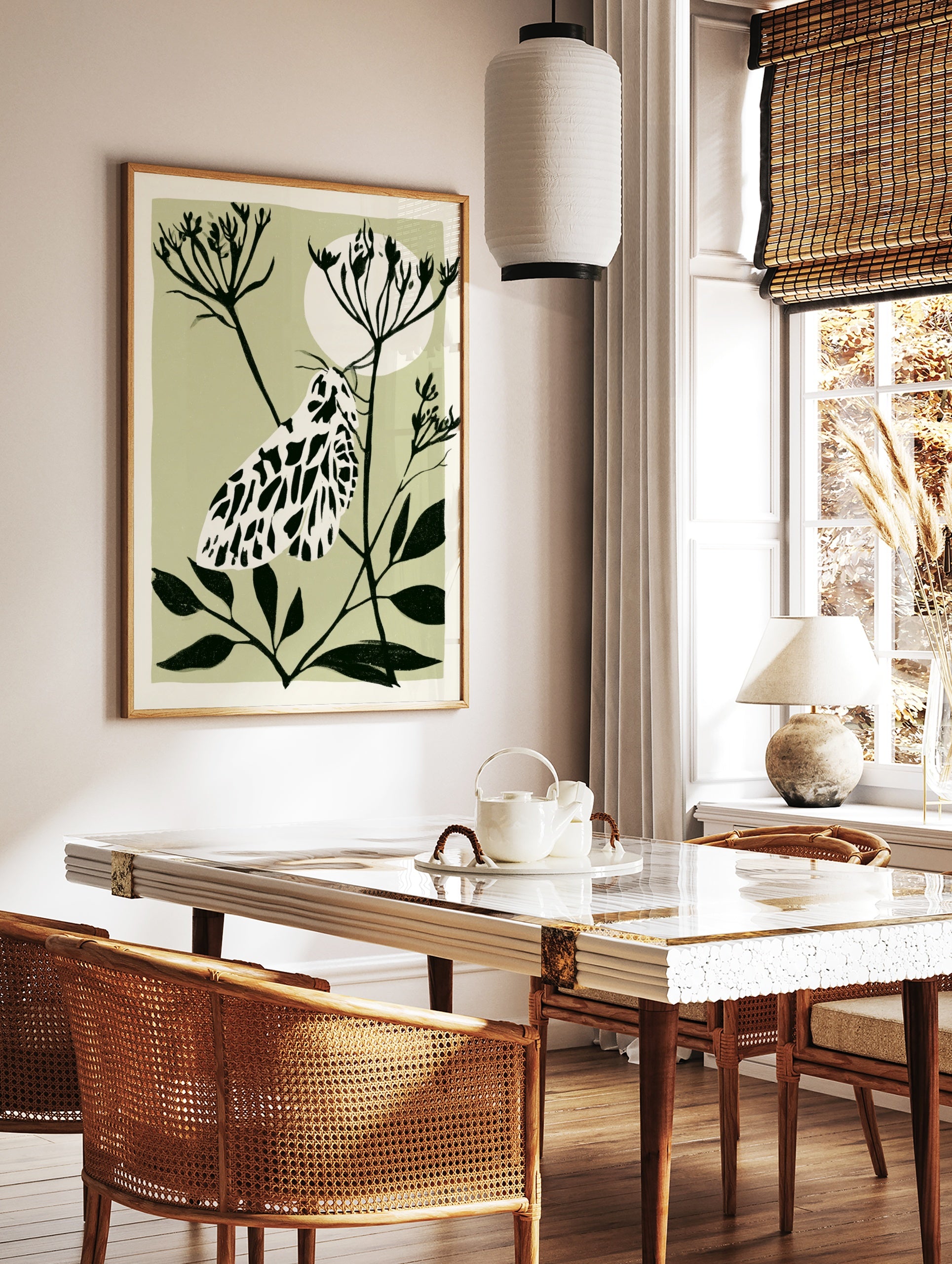 Illustrative moth botanical art print with black and white insect on a plant stem against a pale, in a styled room mockup