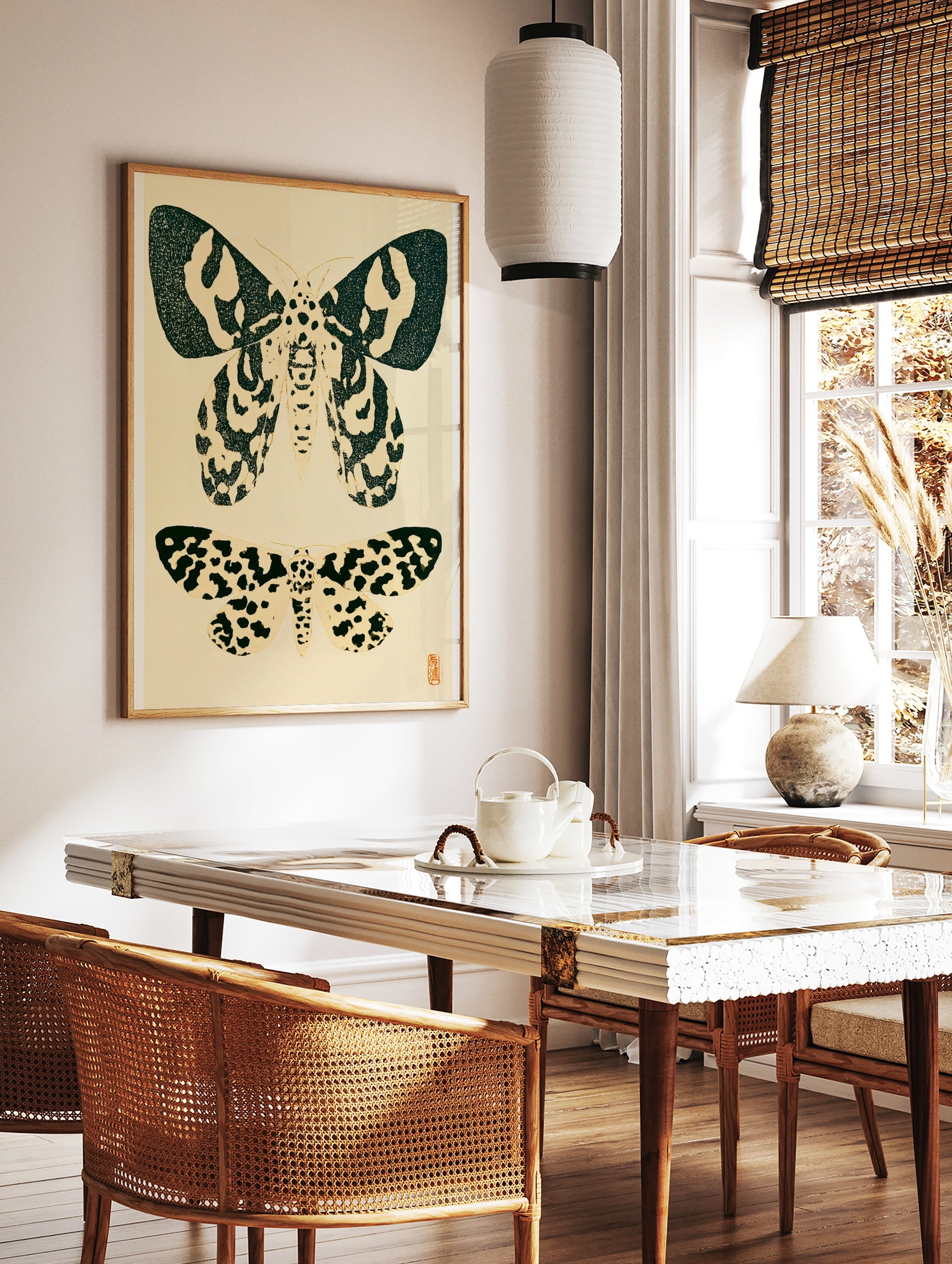 Vintage style moth illustration print with two insects in black ink on a cream background, in a styled room mockup