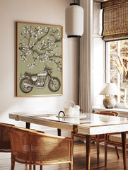Vintage motorcycle parked under blooming cherry blossom tree in illustrative green, white, and, in a styled room mockup