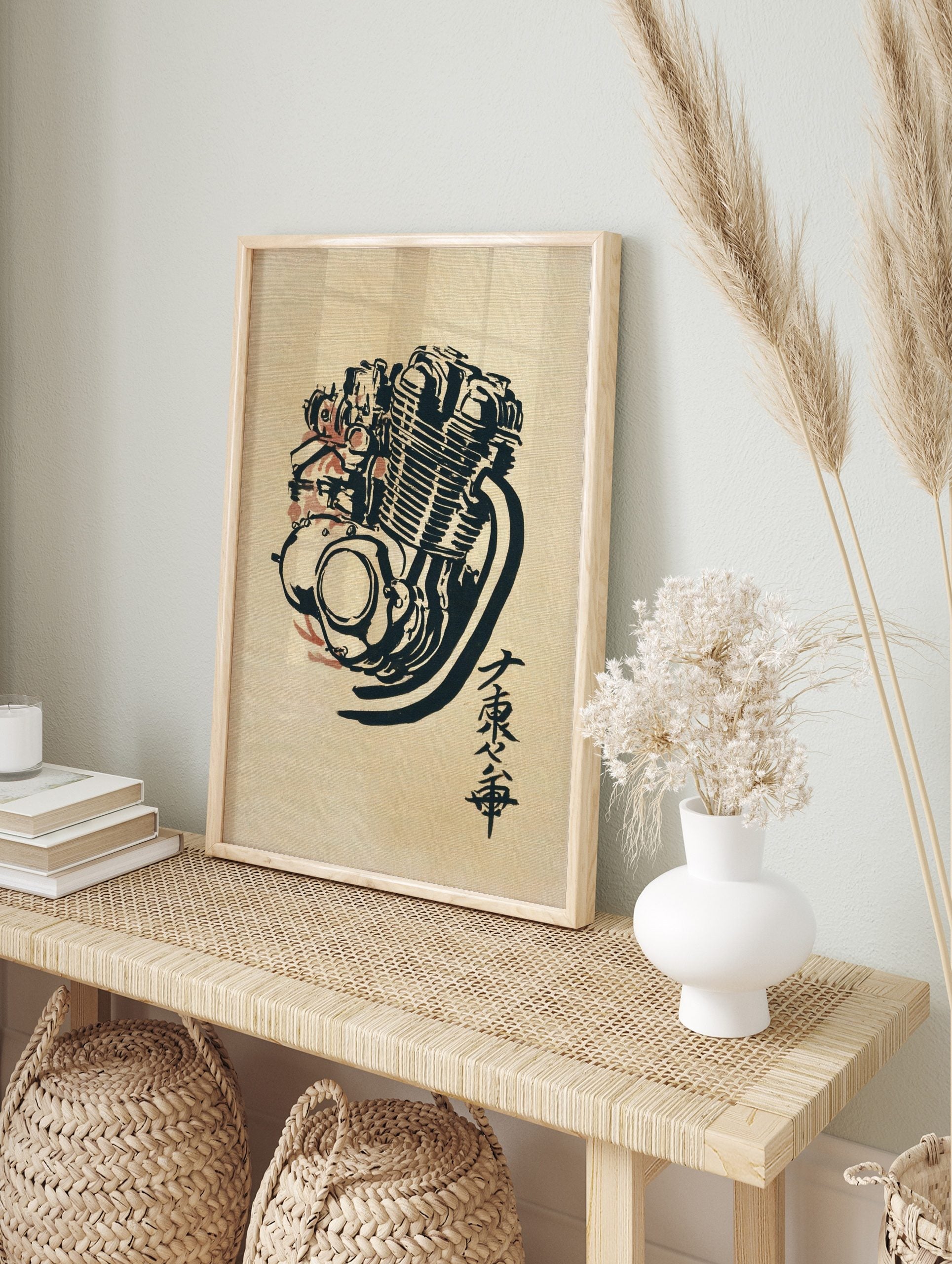 Stylised motorcycle engine illustration in black ink with red accents and Japanese, in an alternate framed mockup