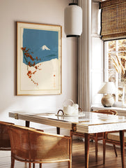 Japanese art print featuring a red flowering branch in the foreground against a blue Mount Fuji, in a styled room mockup