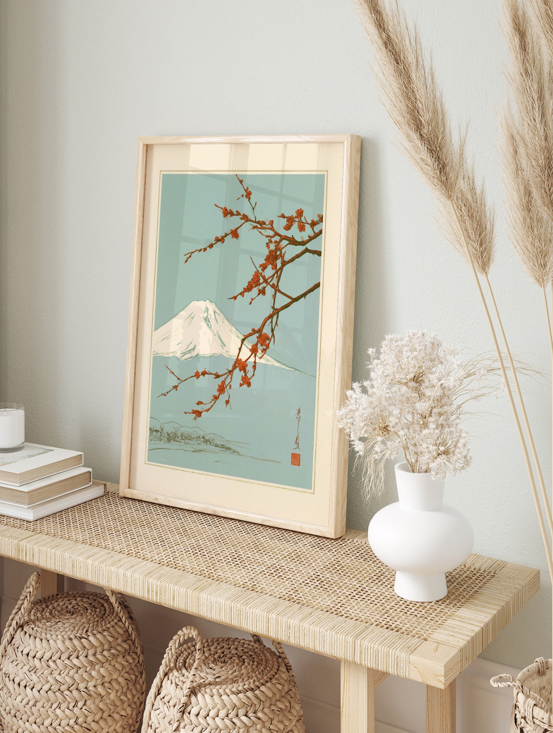 Japanese art print featuring a snow-capped Mount Fuji behind a branch of vibrant red plum, in an alternate framed mockup