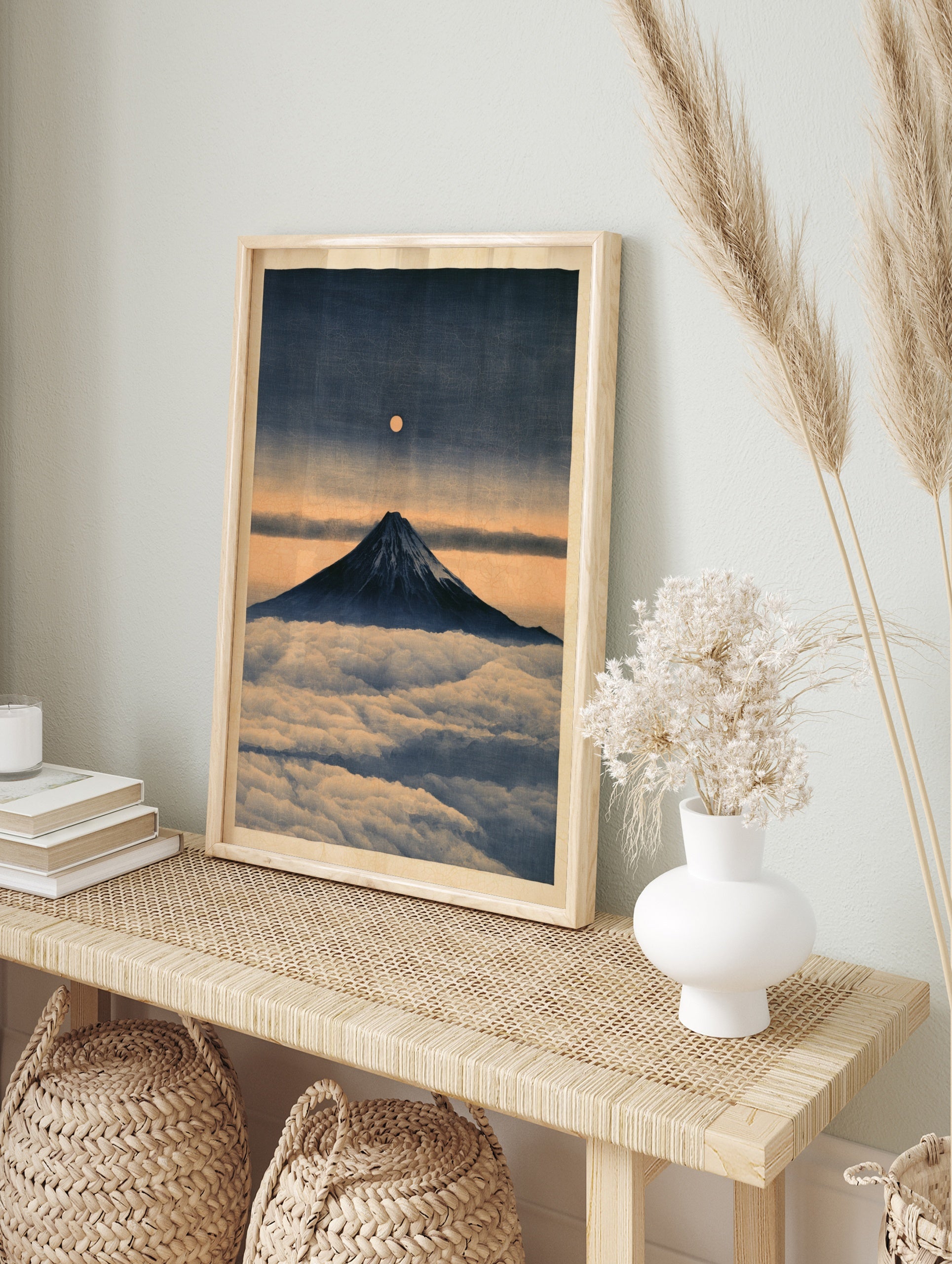 Japanese art print of Mount Fuji rising above clouds with a glowing full moon in a deep blue, in an alternate framed mockup