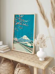 Japanese art print of Mount Fuji, Shinkansen train, and cherry blossoms under a bright blue, in an alternate framed mockup