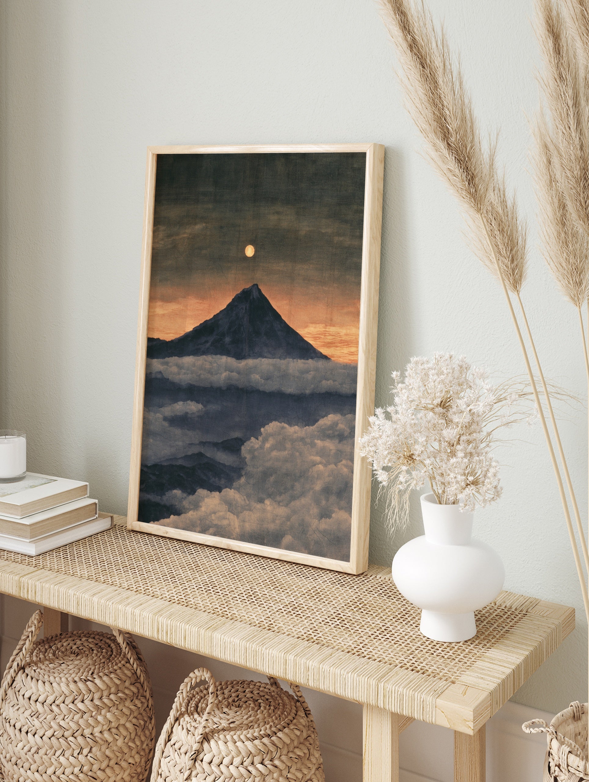 Mountain peak rising above clouds under a full moon in a twilight landscape art print, in an alternate framed mockup