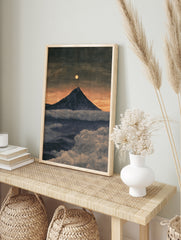 Mountain peak rising above clouds under a full moon in a twilight landscape art print, in an alternate framed mockup