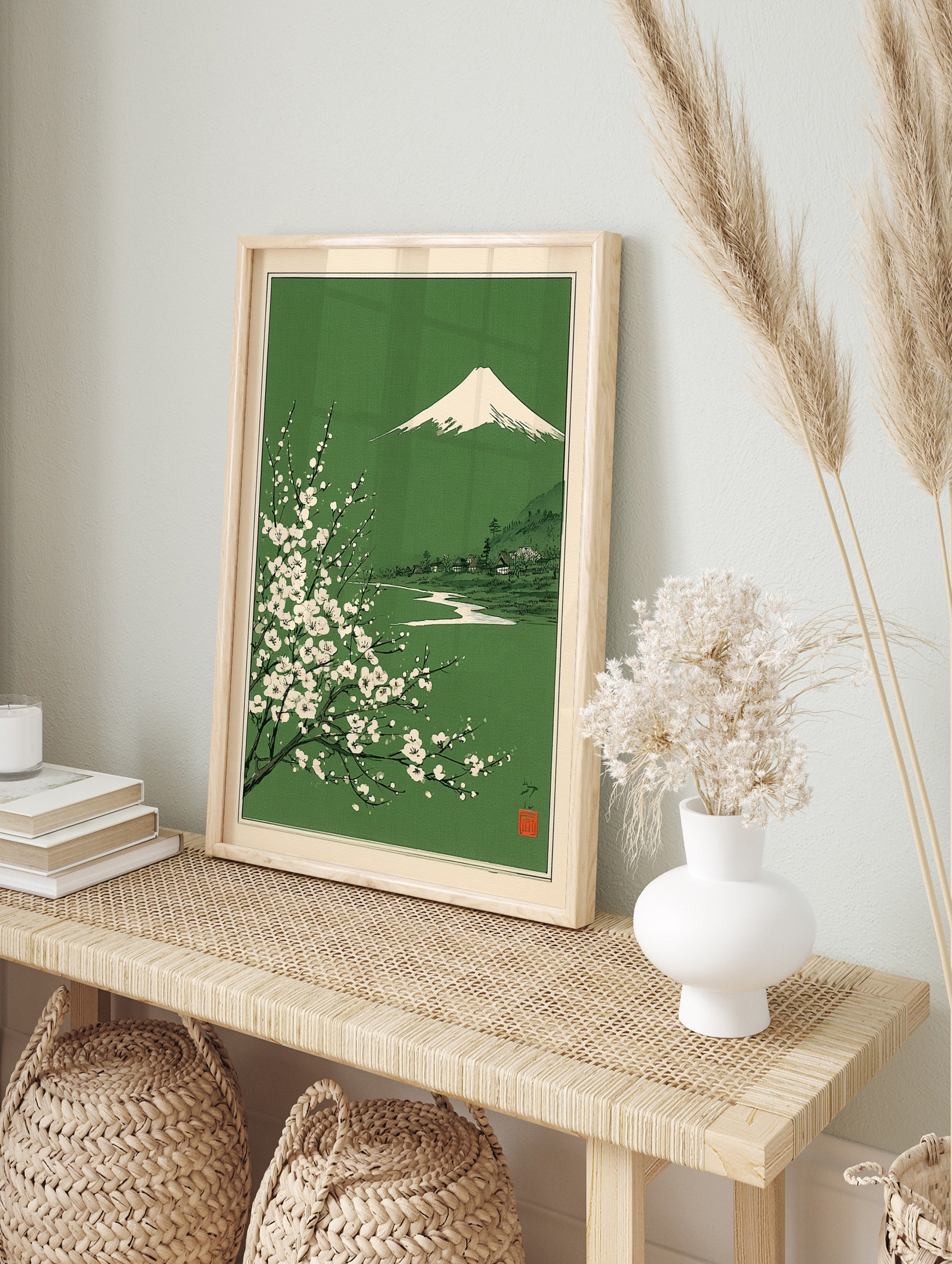 Japanese landscape art print with Mount Fuji, white blossoms, and a village on a green, in an alternate framed mockup