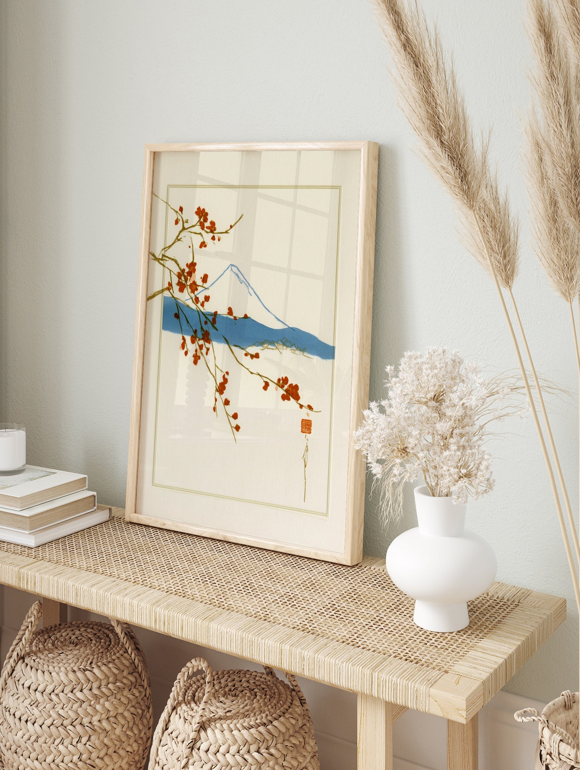 Japanese-style wall art print of Mount Fuji with red cherry blossom branches on a cream, in an alternate framed mockup