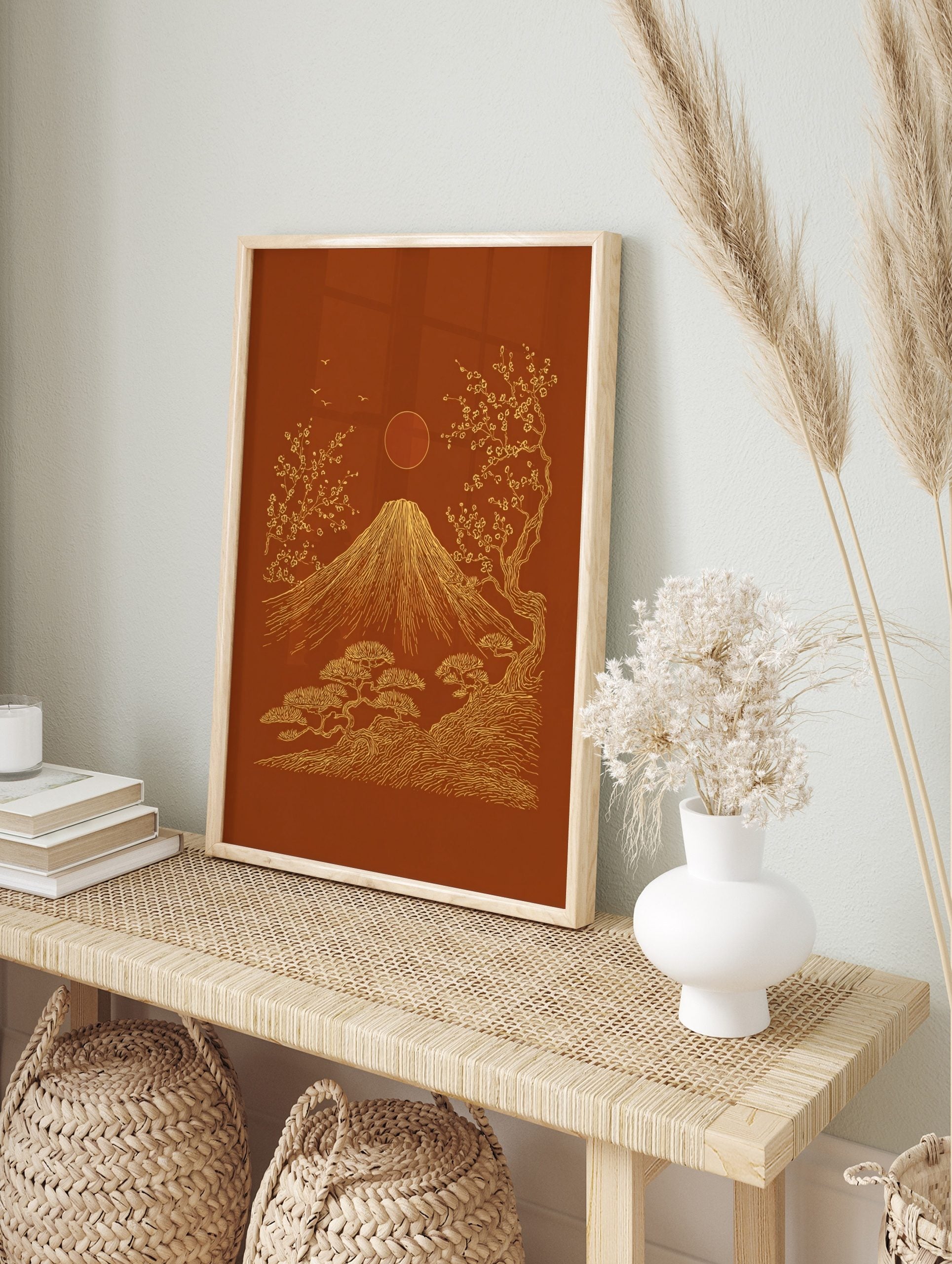 Mount Fuji, cherry blossoms, pine trees, sun, and birds in gold line art on a reddish-brown, in an alternate framed mockup