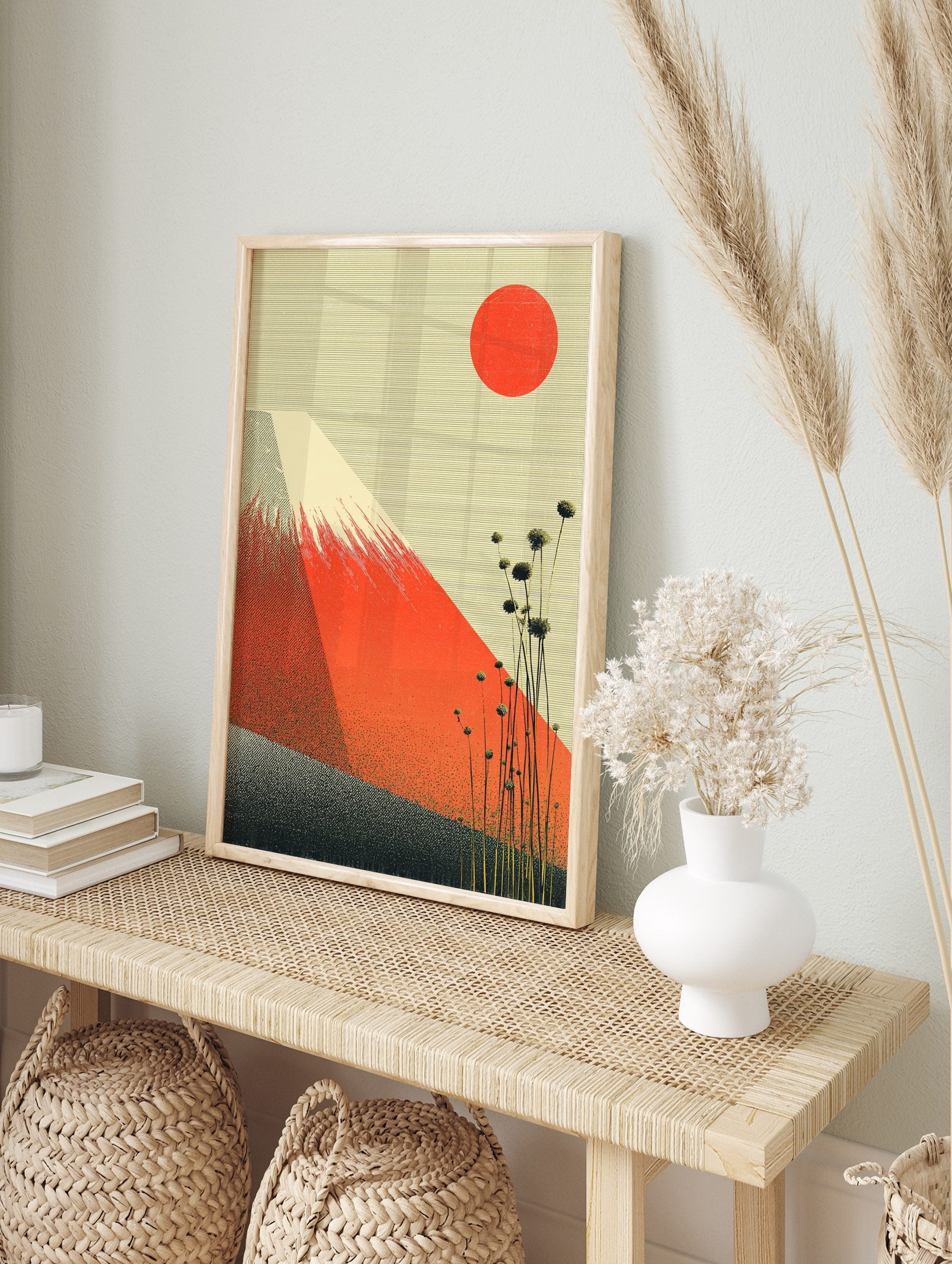 Mount Fuji wall art with red mountain, red sun, tall plants, and textured cream sky in a, in an alternate framed mockup