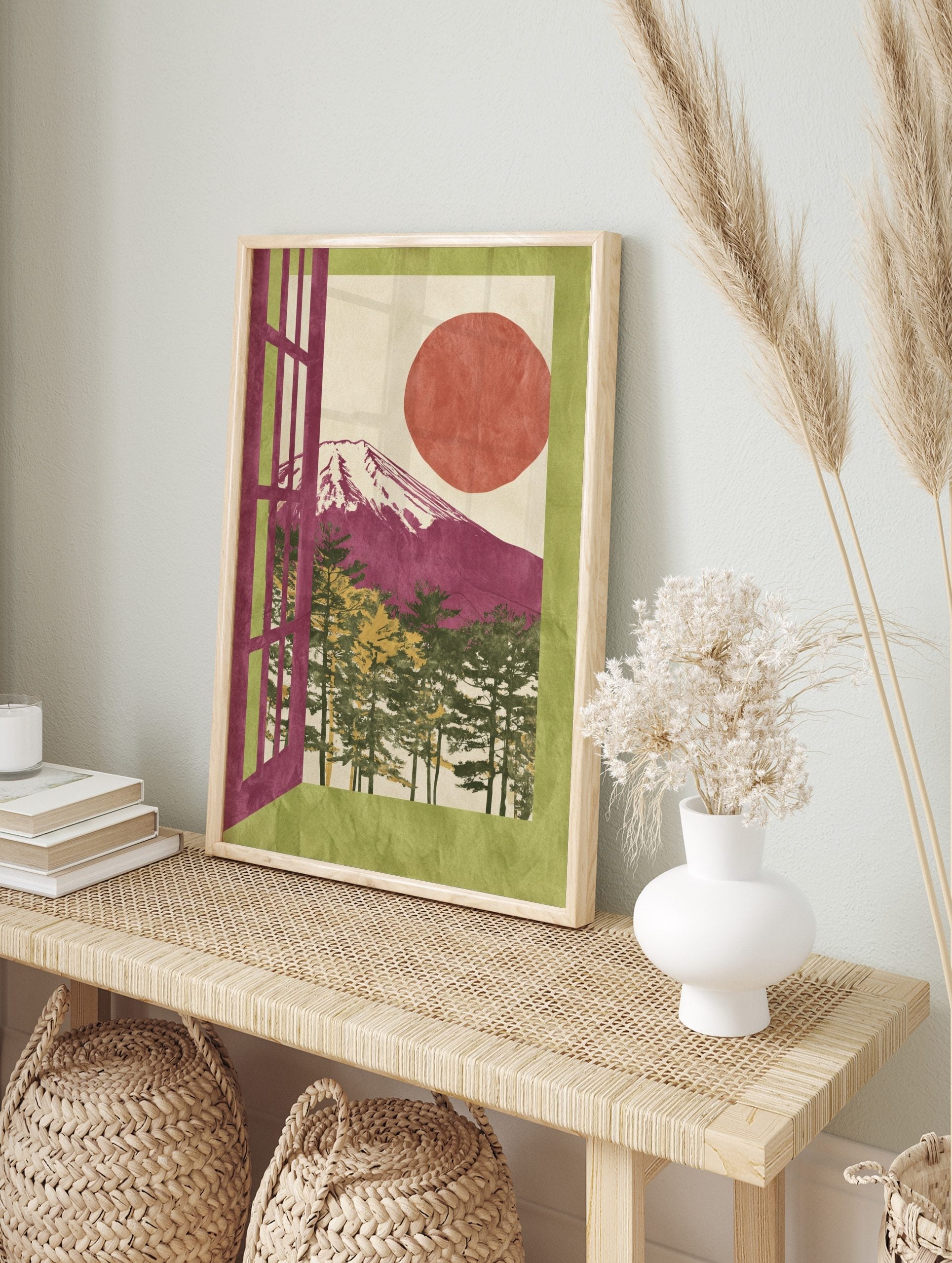 Illustrative Mount Fuji art print with magenta mountain, red sun, pine trees, and green, in an alternate framed mockup