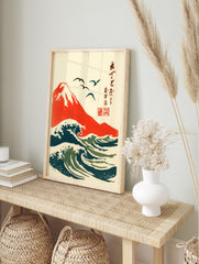 Japanese woodblock style art print of red Mount Fuji, dark blue and green ocean waves, and, in an alternate framed mockup