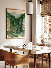 Illustration of two hikers on a winding path through a green mountain forest with wildflowers in, in a styled room mockup