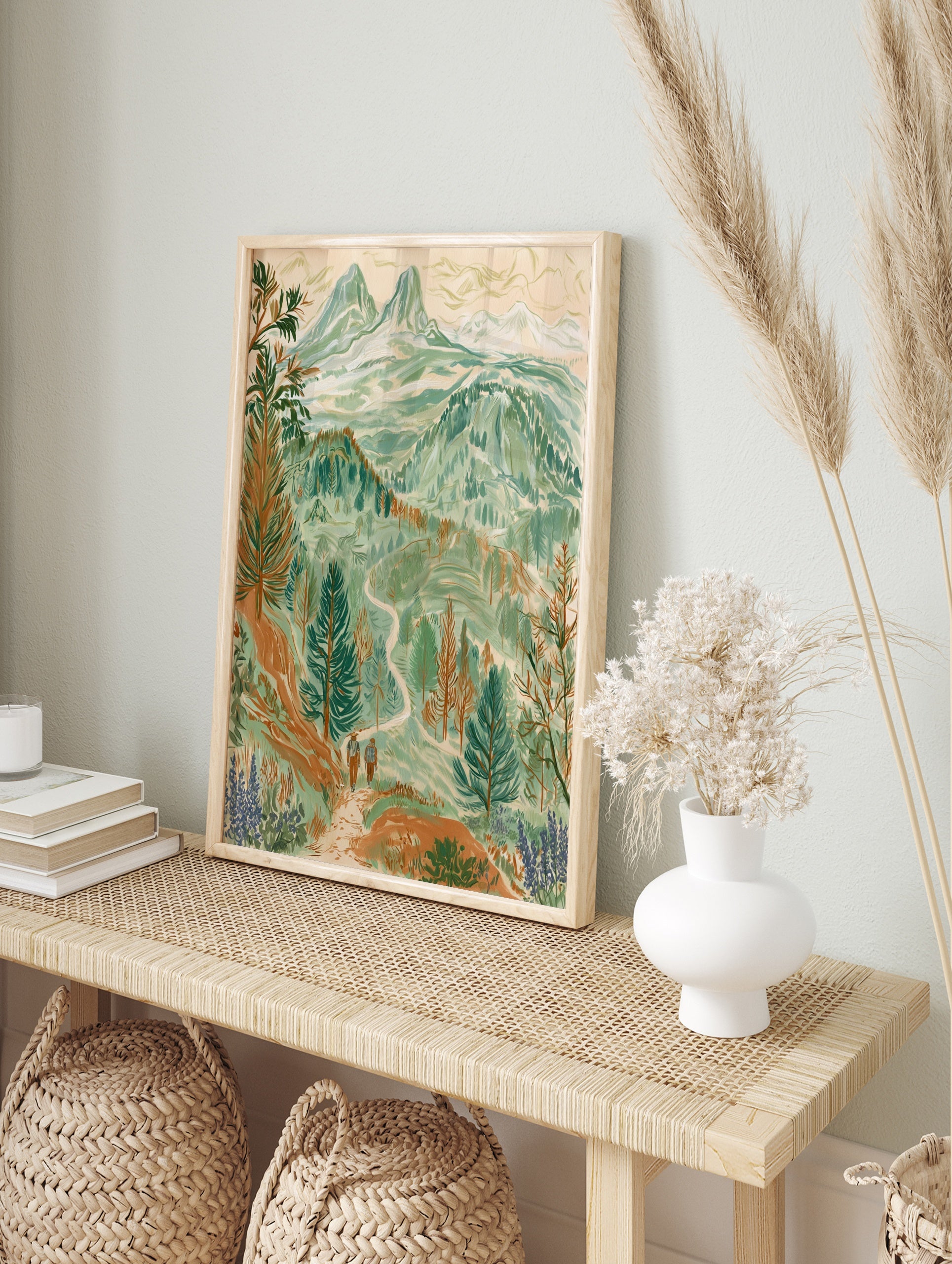 Illustrative mountain landscape wall art print featuring two hikers on a trail with pine, in an alternate framed mockup