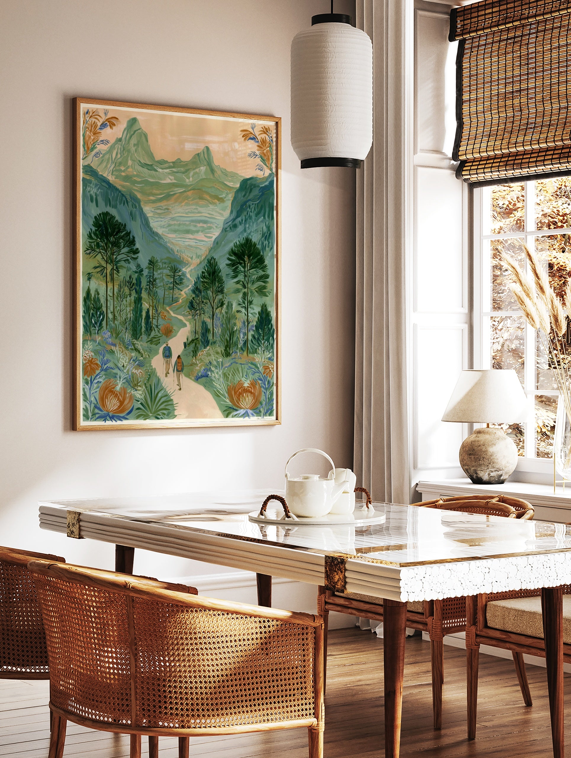 Illustrative mountain valley scene with two hikers on a path and large orange flowers in the, in a styled room mockup