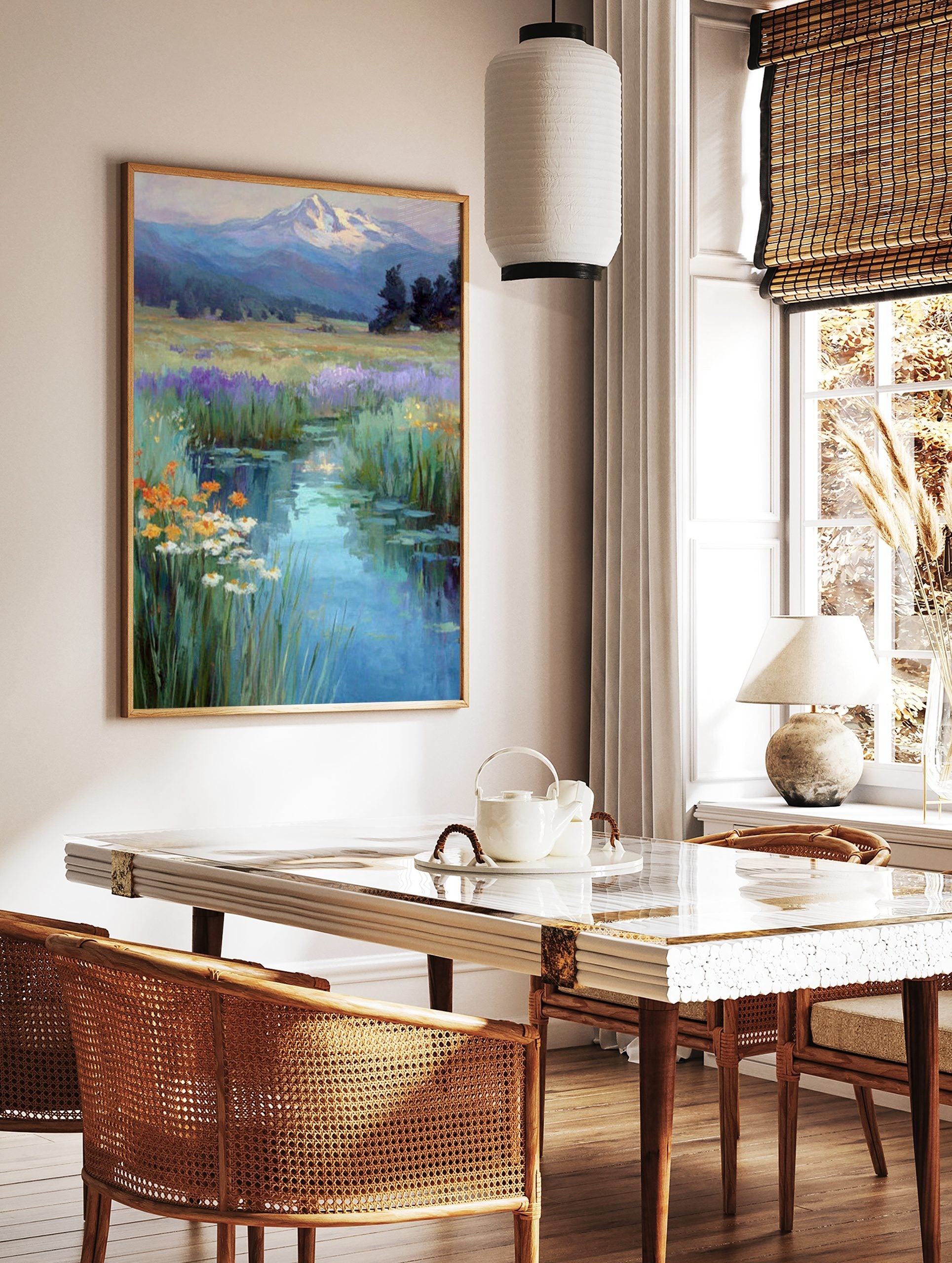 Impressionistic painting of a winding stream through a wildflower meadow towards a snow-capped, in a styled room mockup