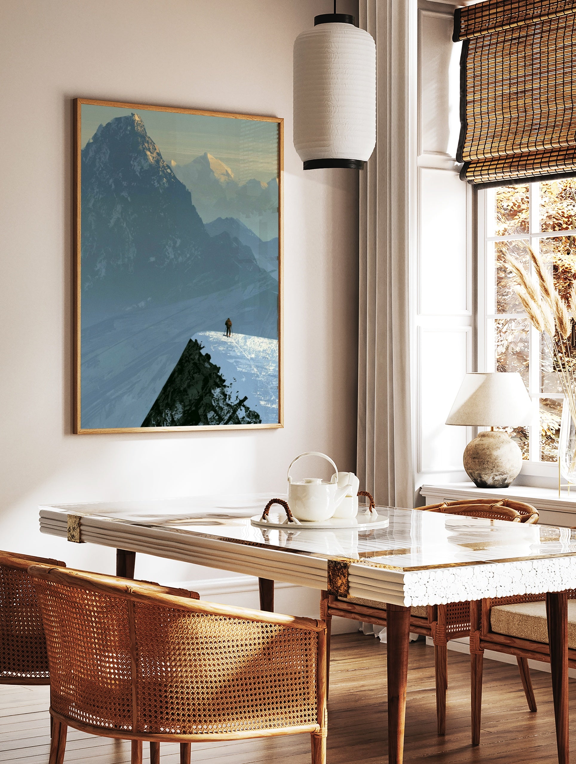 Illustrative mountain landscape art print showing a lone skier on a snowy ridge against a backdrop, in a styled room mockup
