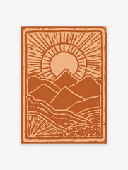 Stylised orange mountain landscape art print with a radiant sun and textured foreground, framed by a border