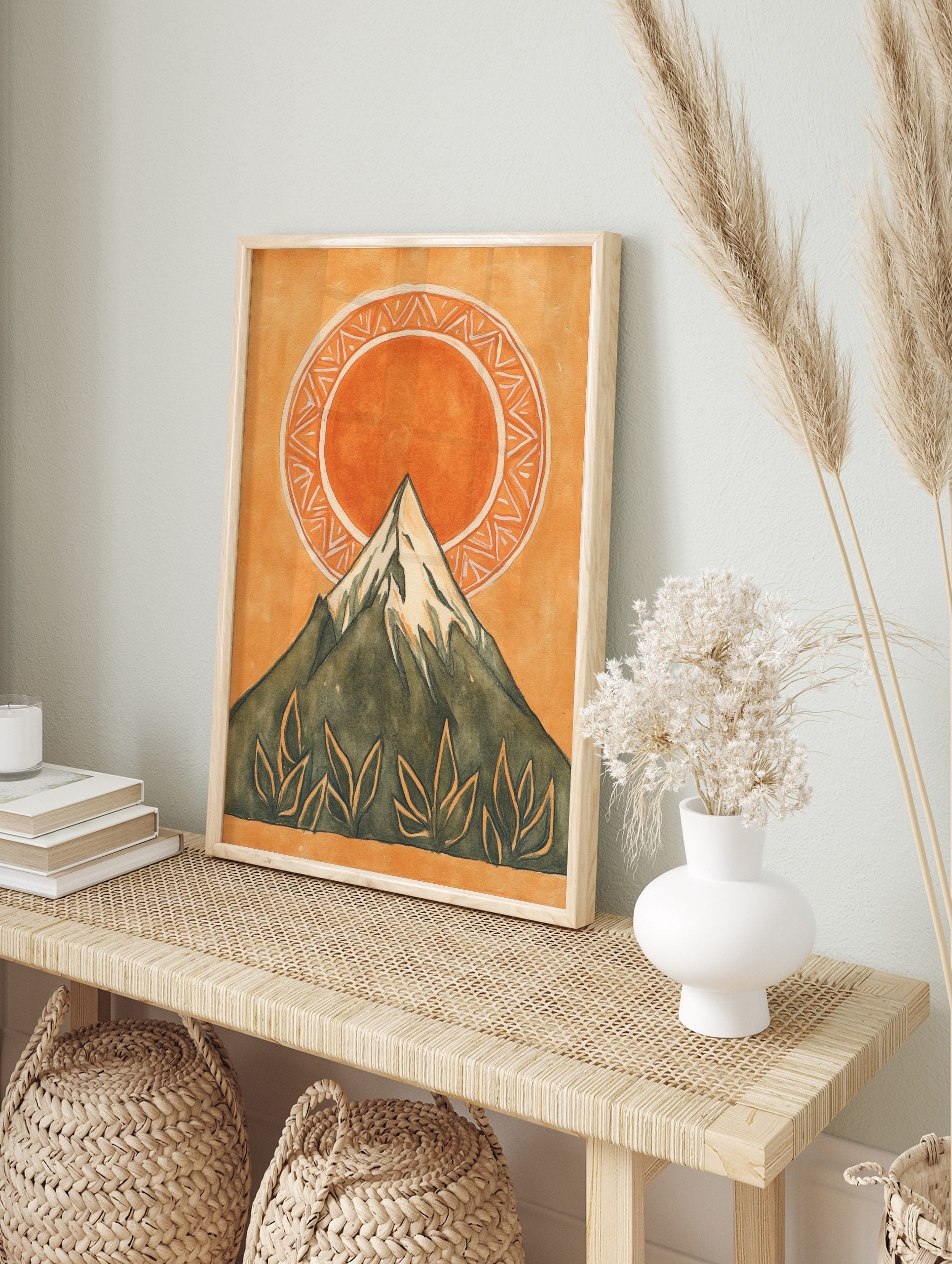 Illustrative mountain and sun wall art print with green peak, orange sun, patterned circle, in an alternate framed mockup