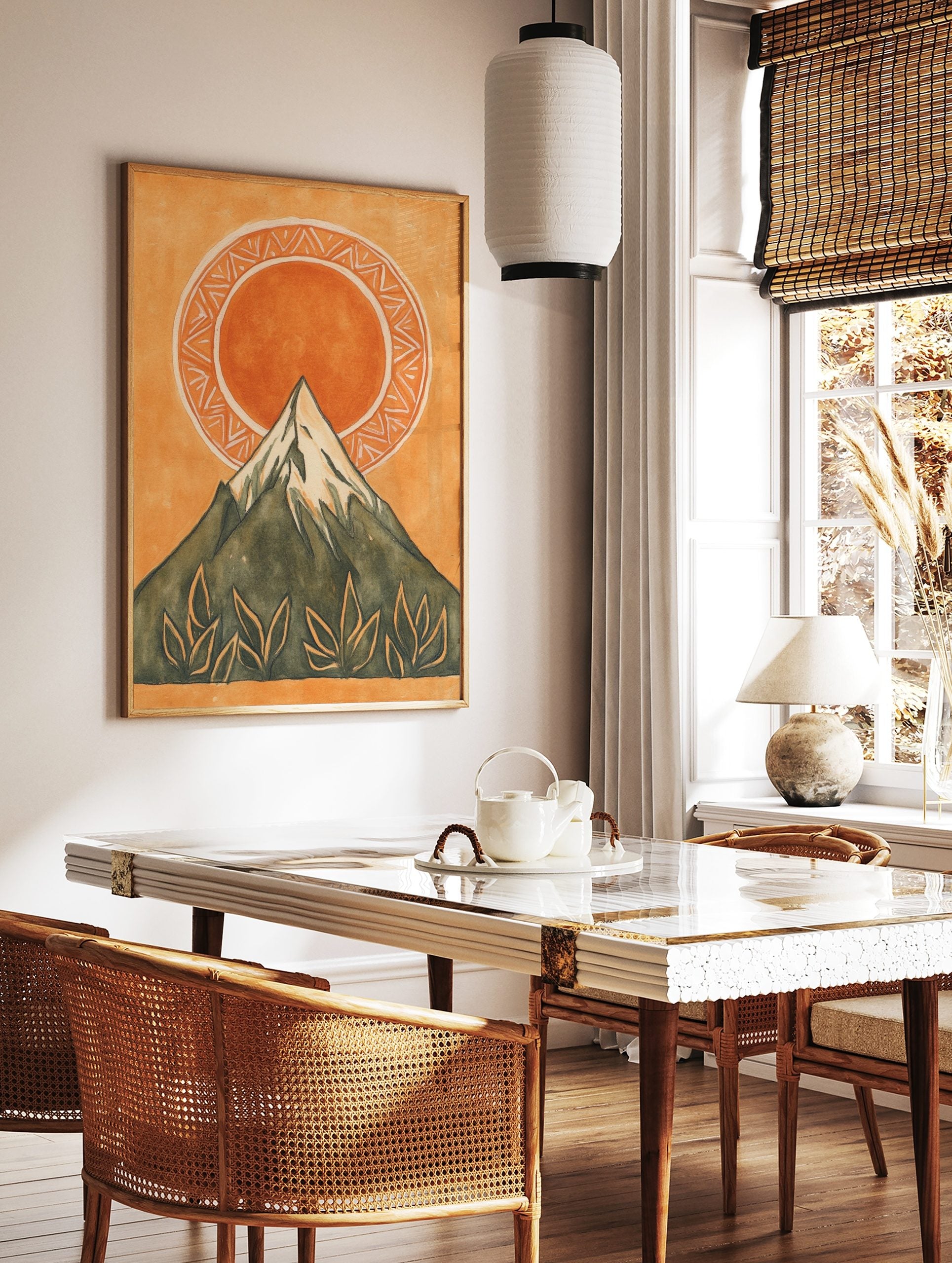 Illustrative mountain and sun wall art print with green peak, orange sun, patterned circle, and, in a styled room mockup