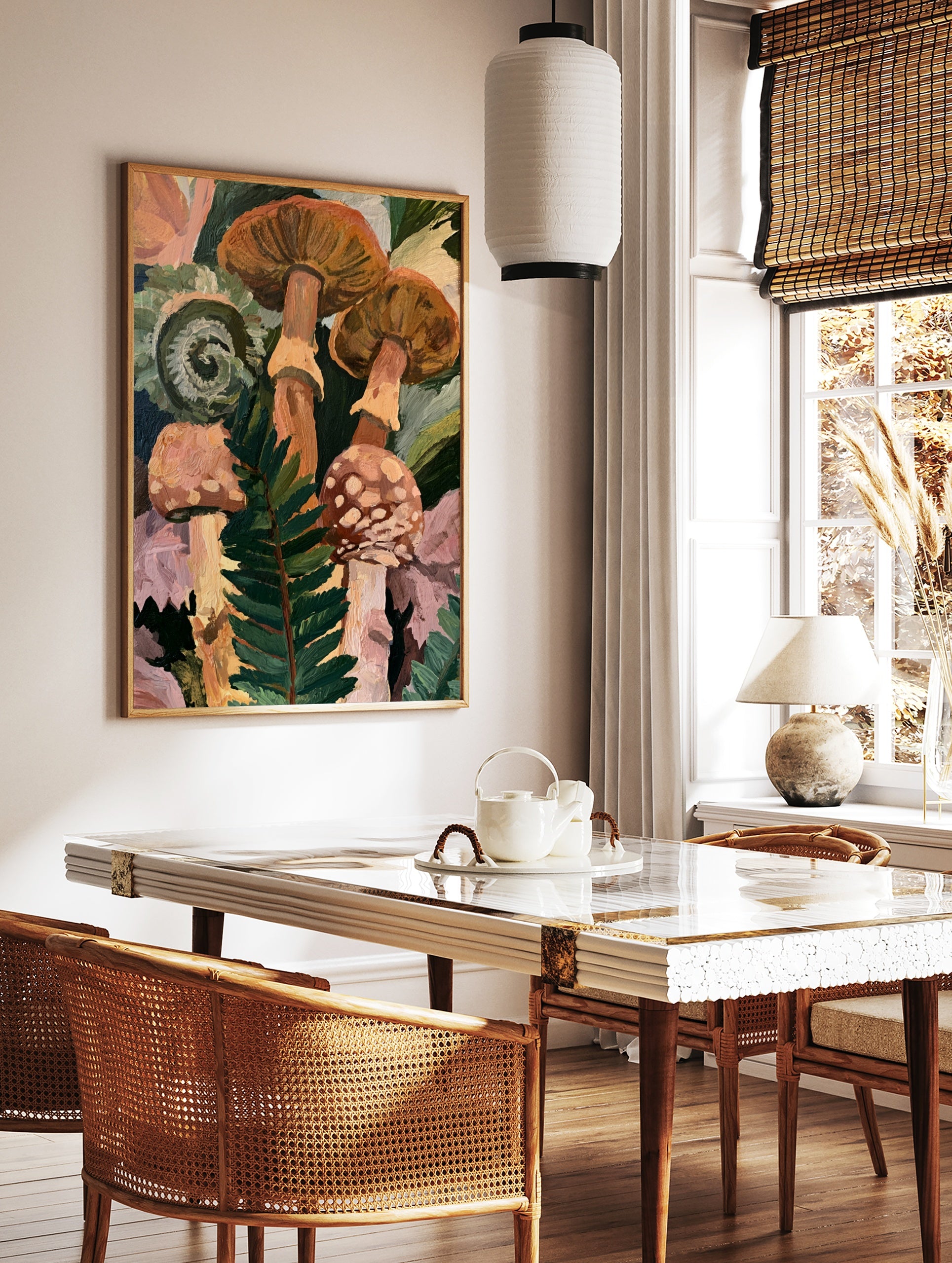 Botanical art print of forest mushrooms and a curled fern frond in shades of orange, green, and, in a styled room mockup