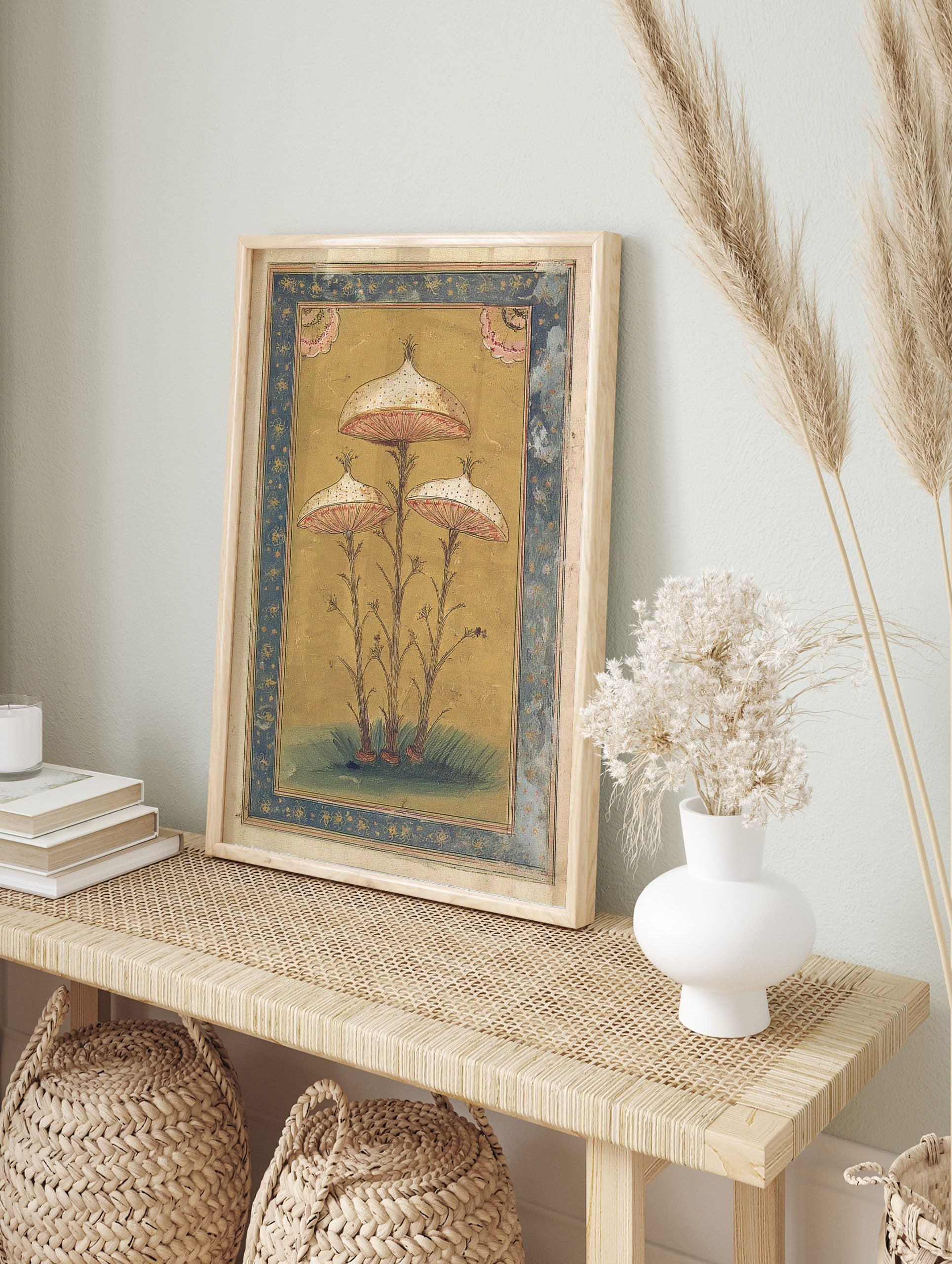 Botanical illustration of three ornate mushrooms with speckled caps and pink gills, framed by, in an alternate framed mockup