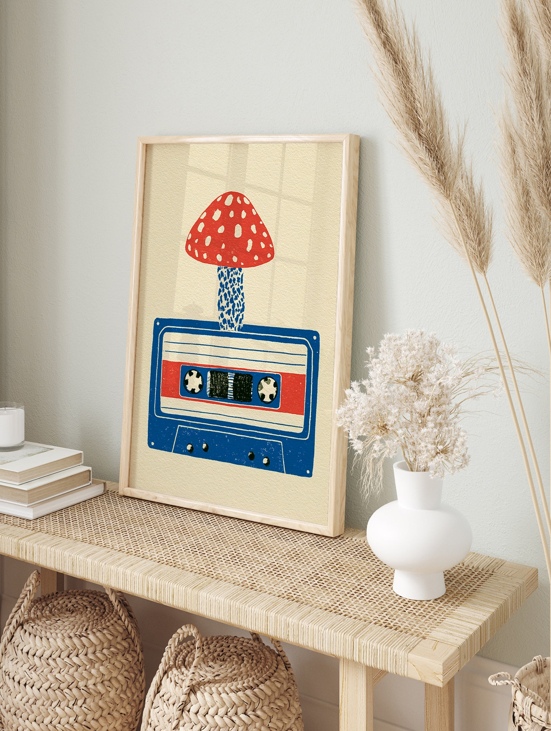 Illustrative art print of a red spotted mushroom growing from a blue cassette tape on a cream, in an alternate framed mockup
