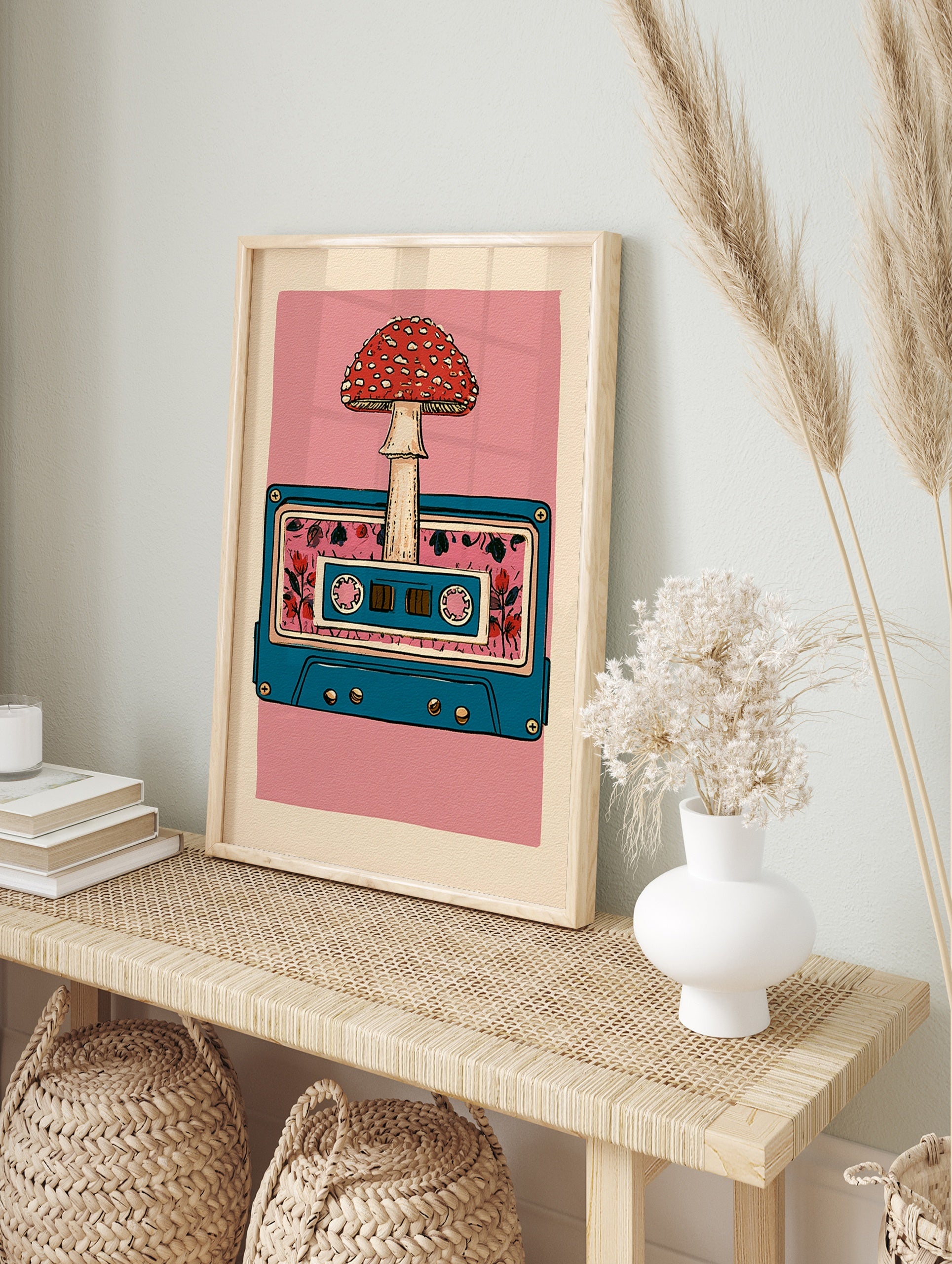 Retro cassette tape illustration with a red mushroom and floral pattern on a pink background, in an alternate framed mockup