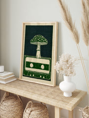 Illustrative art print of a mushroom growing out of a retro cassette tape in green and, in an alternate framed mockup