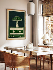 Illustrative art print of a mushroom growing out of a retro cassette tape in green and off-white, in a styled room mockup
