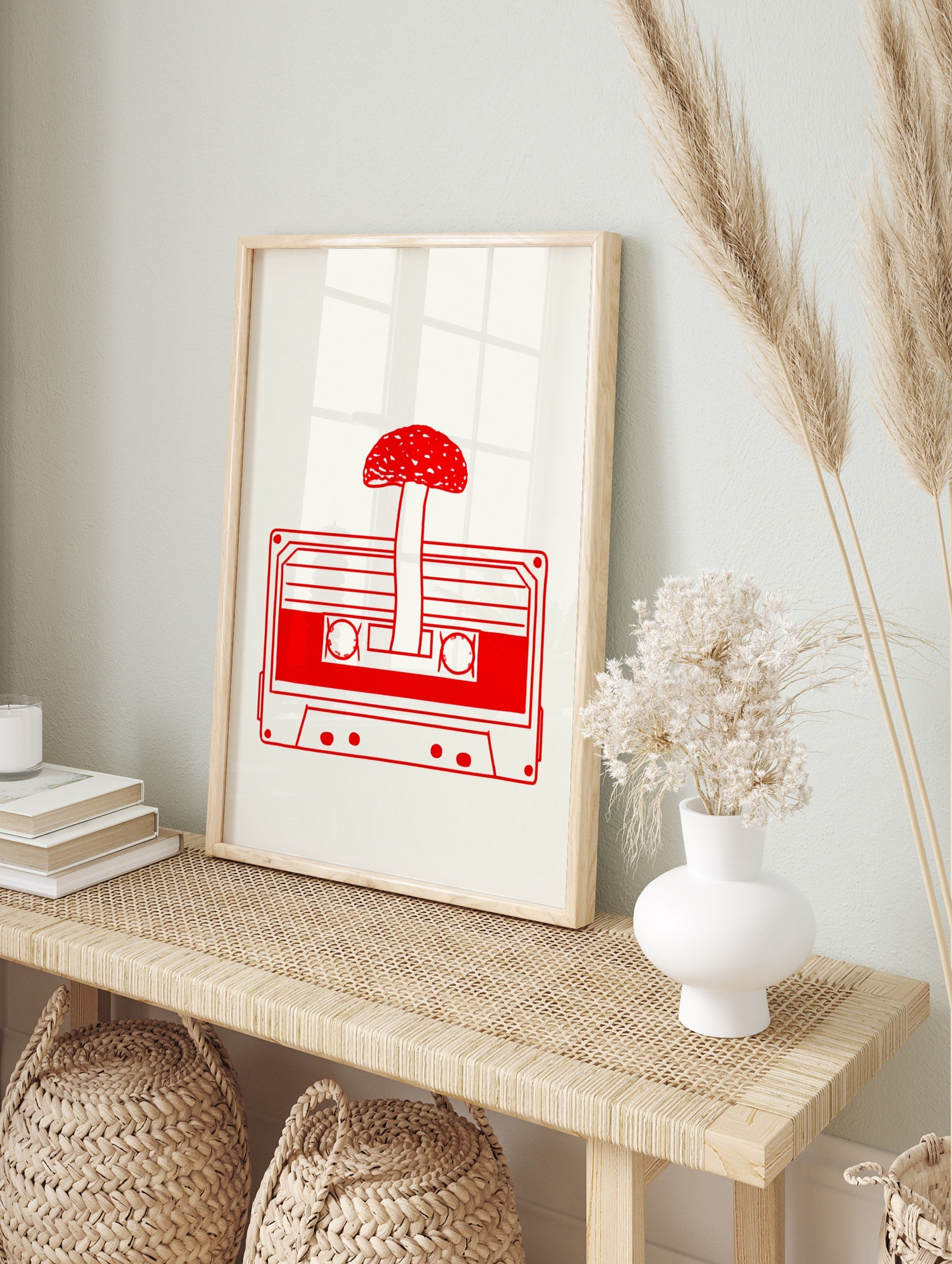 Minimalist red line art of a mushroom growing from a cassette tape on a cream background, in an alternate framed mockup