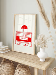 Minimalist red line art of a mushroom growing from a cassette tape on a cream background, in an alternate framed mockup