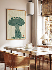 Green woodcut-style mushroom botanical print with textured gills and cap on a cream background, in a styled room mockup