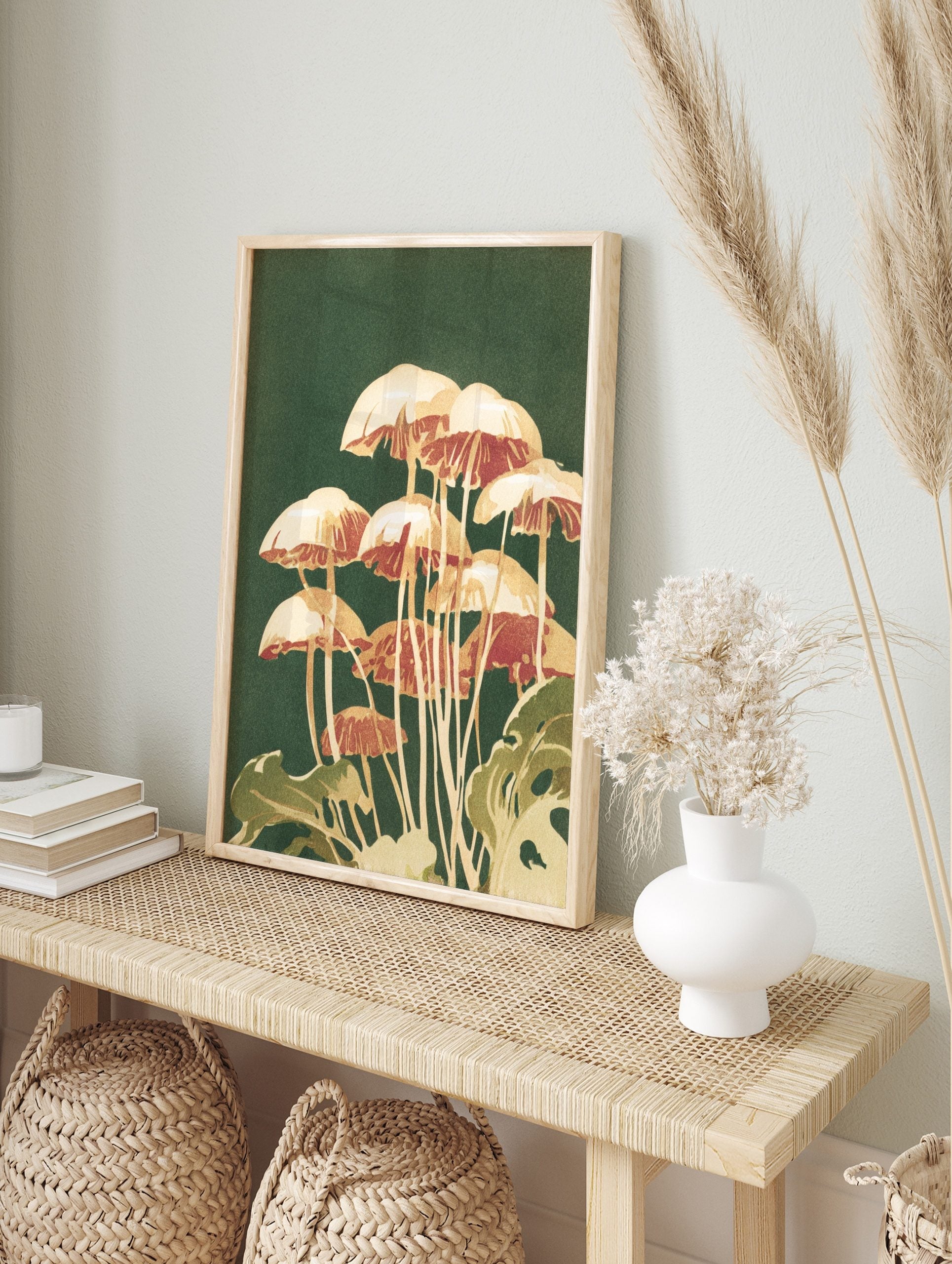 Illustrative print of cream and reddish-brown mushrooms with green foliage on a dark green, in an alternate framed mockup