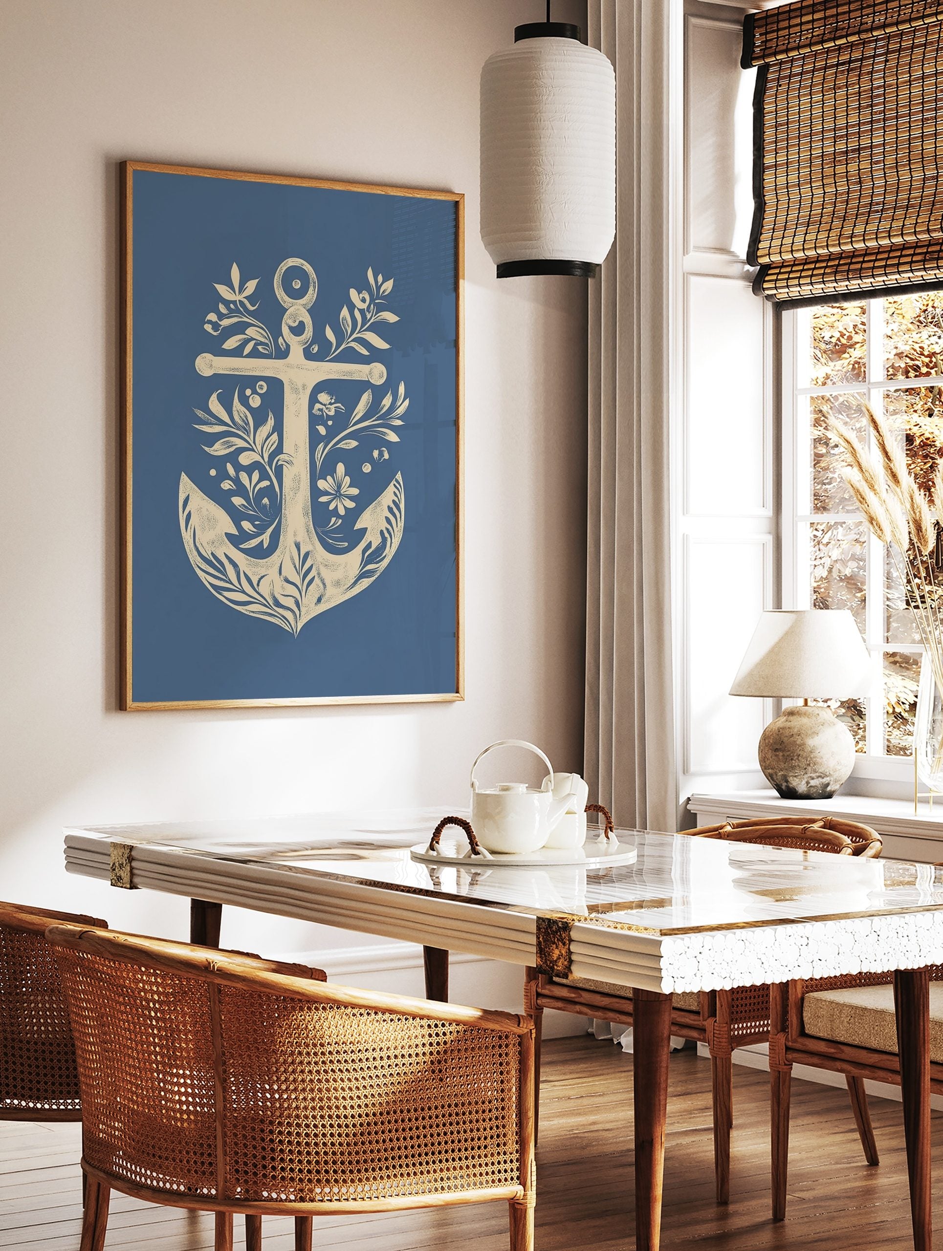 Decorative nautical anchor illustration art print with botanical leaves, flowers, and berries on a, in a styled room mockup