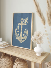 Cream anchor with botanical leaves and flowers on a blue background in an illustrative style, in an alternate framed mockup