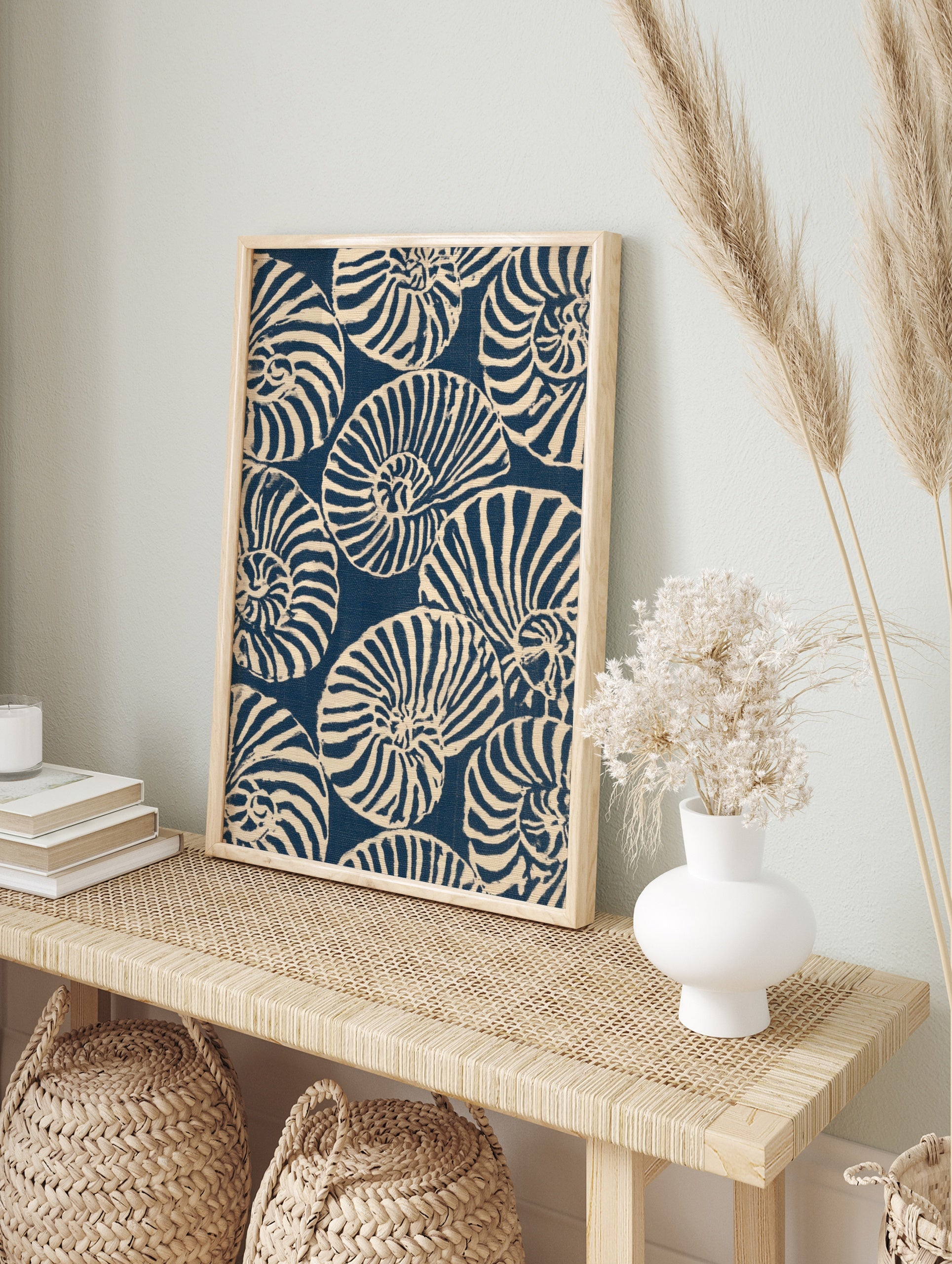 Repeating pattern of navy blue and off-white nautilus seashells in an illustrative graphic, in an alternate framed mockup