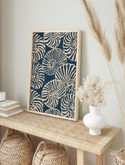 Repeating pattern of navy blue and off-white nautilus seashells in an illustrative graphic, in an alternate framed mockup